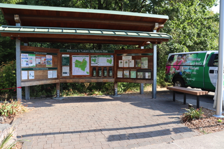 Bench near covered informational kiosk - park rules - class activities - general information